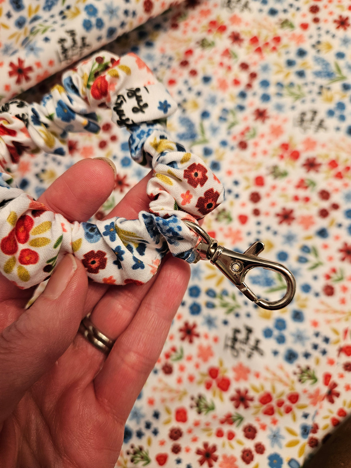 Scrunchie-style Catholic fabric wristlets with clasp claw as a keychain